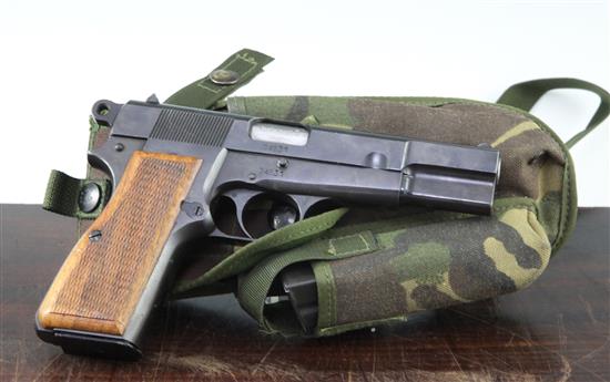 A de-activated Browning mark II high power 9mm automatic pistol,